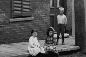 Screenshot from "The Rise and Fall of English Montreal (NFB, 1003) showing English-speaking children in a less affluent part of Montreal in the late 1800s.